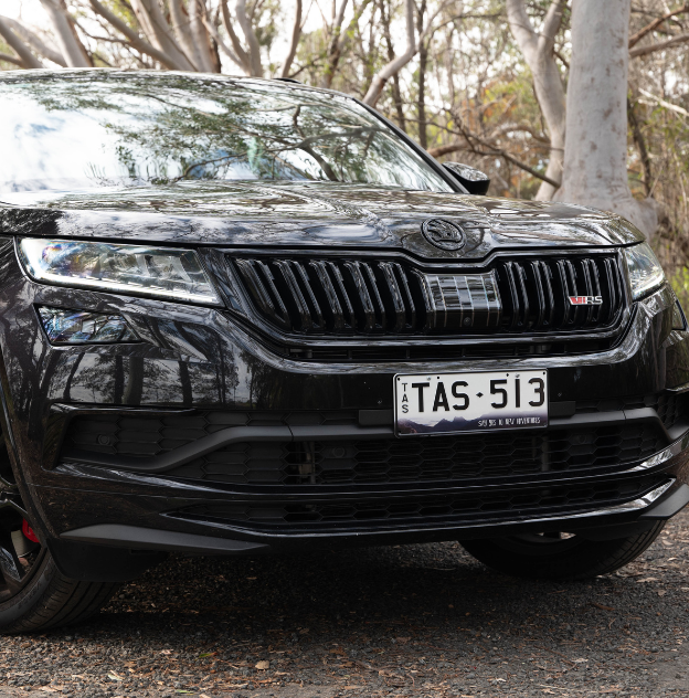 Explore New Adventures plates on a Black Skoda